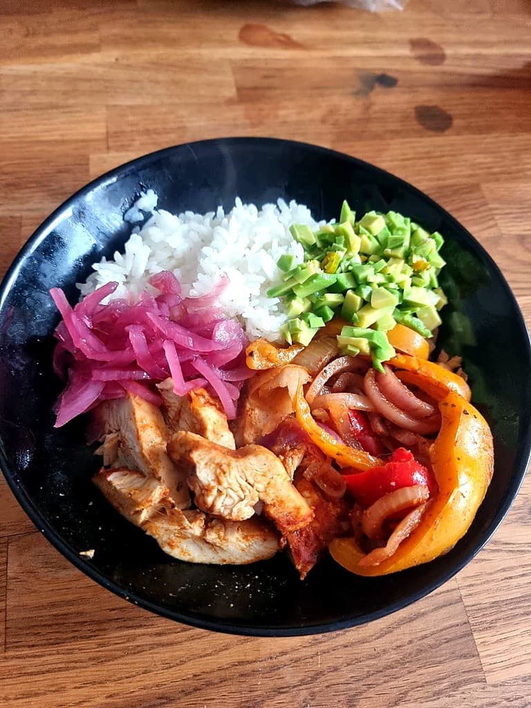 A colourful chicken and rice bowl made by a PMOS Trainers client